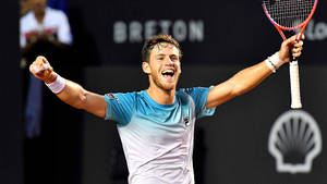 Diego Schwartzman Raising His Arms Triumphantly Wallpaper