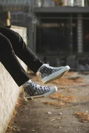 Dior High Top Sneakers On Feet Wallpaper