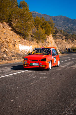 Dirt Rally Car In Red Paint Wallpaper