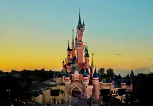 Disneyland Paris Against Blue And Yellow Sky Wallpaper