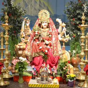 Divine Vaishno Devi Statue Adorned With Fresh Flowers Wallpaper