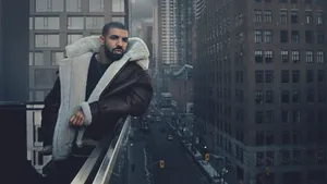 Drake Showcasing Ovo Merchandise Wallpaper