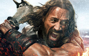 Dwayne Johnson In Character As Hercules, Displaying His Formidable Physique And Intense Expression. Wallpaper