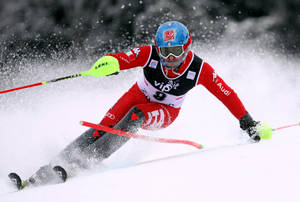 Dynamic Alpine Skiing In Full Swing Wallpaper