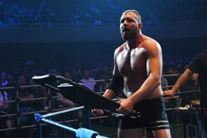 Dynamic Jon Moxley In-action At A Wrestling Event Wallpaper