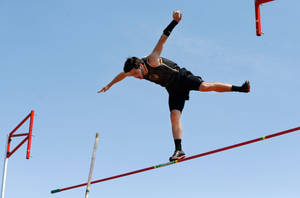 Dynamic Pole Vault Action Wallpaper