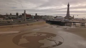 Earth Sculpture In The Sands Near The Iconic Blackpool Tower Wallpaper