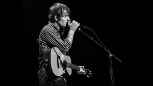 Ed Sheeran Strumming Away In Front Of A Live Audience Wallpaper