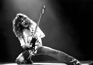 Eddie Van Halen Kneeling Onstage Wallpaper