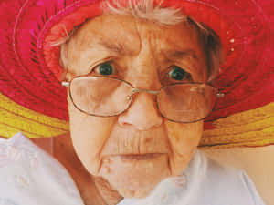 Elderly Woman Colorful Hat Wallpaper