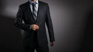 Elegant Businessman In Sophisticated Suit Wallpaper