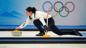 Elegant Female Curling Athlete Wallpaper