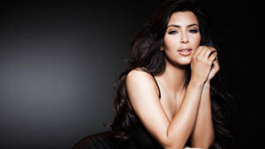 Elegant Kim Kardashian Poses In The Dark Wallpaper