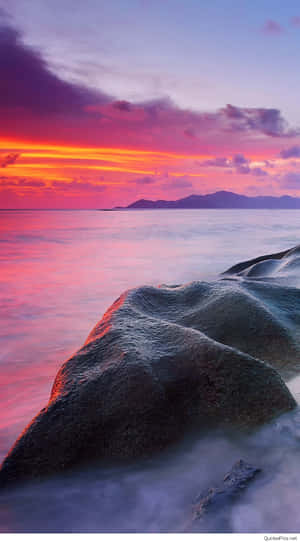 Embrace The Beauty Of Nature With A Sunset Beach View. Wallpaper