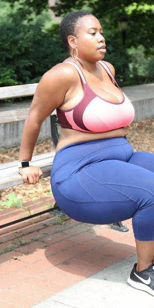 Empowered Black Woman Performing Bench Press Wallpaper