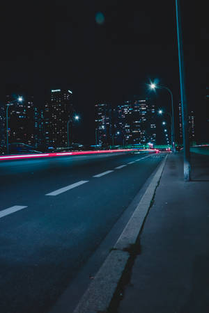 Empty Street With Lights During Nighttime Wallpaper