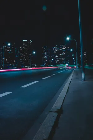 Empty Street With Lights During Nighttime Wallpaper