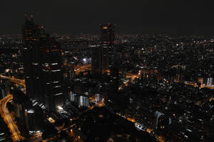 Enchanting Cityscape Of Tokyo Illuminated By Neon Lights Wallpaper