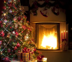 Enchanting Fireplace Christmas Setup On A Cool Winter Night Wallpaper