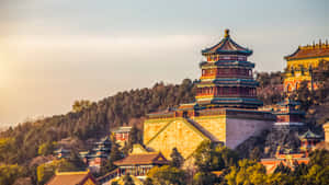 Enchanting Summer Palace Surrounded By Lush Green Trees Wallpaper