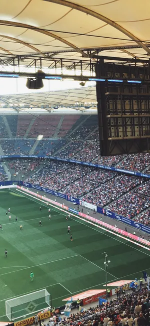 Enjoy The Electrifying Atmosphere Of The Soccer Stadium Wallpaper