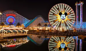 Enjoy The Magical View Of Pixar Pier At Night Wallpaper
