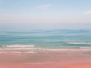 Enjoy The Pink Ocean Horizon For A Peaceful Beach Aesthetic Wallpaper