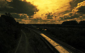 Enjoy The Sunset Journey On A Golden Train Wallpaper