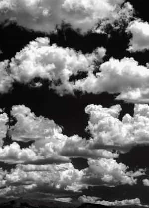 Enjoy The Thunderstorm With The Beautiful Black And White Clouds Wallpaper