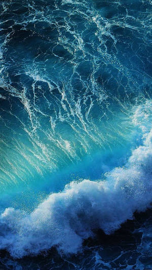 Enjoy The View Of The Ocean Waves At Anytime With An Iphone Wallpaper