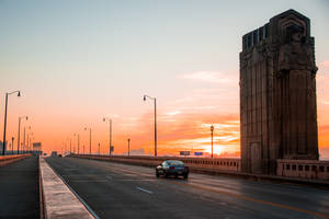 Enjoying The Sunset Over Cleveland's Bridge Wallpaper