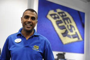 Enthusiastic Best Buy Employee Ready To Assist Customers Wallpaper