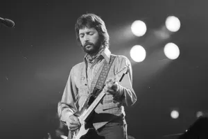 Eric Clapton Playing Guitar On Stage Wallpaper