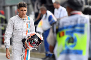 Esteban Ocon Holding His Racing Helmet During A Racing Event Wallpaper