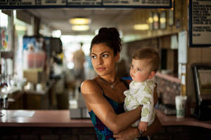 Eva Mendes Cradling A Cute Infant Wallpaper