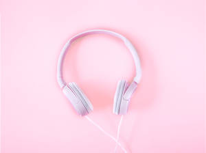 Experience The Beauty Of Music With Our Pink Headphones. Wallpaper
