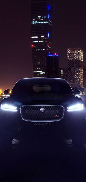 Experience The Power And Elegance Of A Jaguar Car At Night Wallpaper