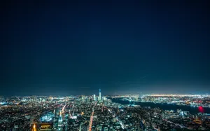 Exploring The Bright City Lights At Night Wallpaper