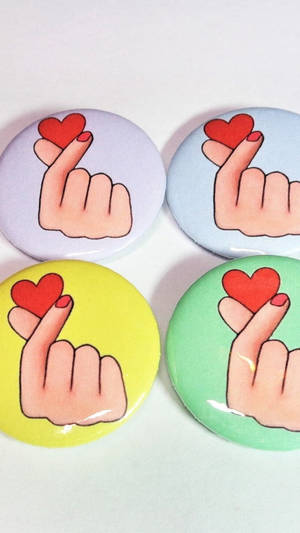 Expressing Love With A Saranghae Finger Heart Pin. Wallpaper