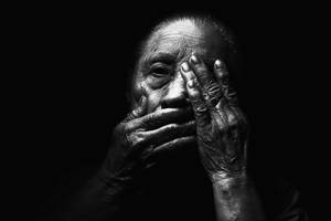 Expressive Portrait Of A Wise Elderly Woman Wallpaper