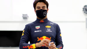 F1 Driver Sergio Perez Wearing A Face Mask Wallpaper