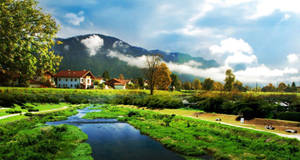 Farmhouse With Scenic Mountain Range Wallpaper