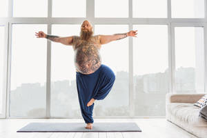 Fat Man In Yoga Stance Wallpaper