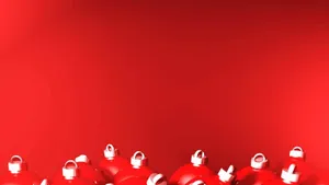 Festive Glistening Christmas Ornaments On A Regal Red Background Wallpaper
