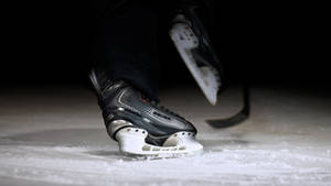 Fierce Ice Skating Blades Of A Hockey Player Wallpaper