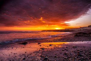 Fiery Orange Aesthetic Sunset At Beach Wallpaper