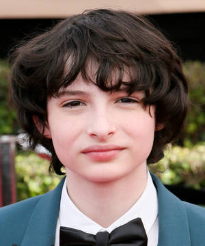 Finn Wolfhard In Blue Suit Wallpaper