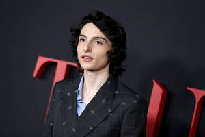 Finn Wolfhard In Fancy Suit Wallpaper