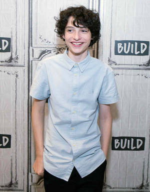 Finn Wolfhard In White Shirt Wallpaper