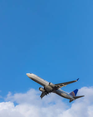 Flying White And Blue Airplane Android Wallpaper